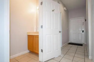 a bathroom with a white door and a sink at Cozy 4BR Regal Oaks close to Disney in Orlando
