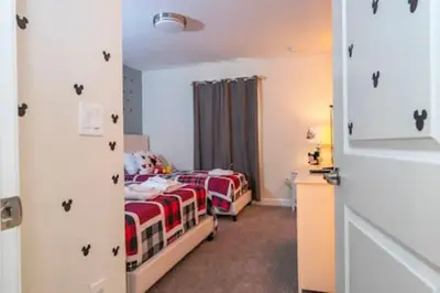 two twin beds in a room with a door at Gorgeous Home with pool and lake view in Kissimmee