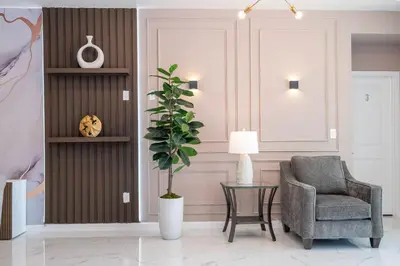 a living room with a chair and a plant at Stunning 15 suites close to Disney in Kissimmee