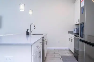 a kitchen with white cabinets and a sink at Gorgeous 4 BR with pool and lake view in Kissimmee