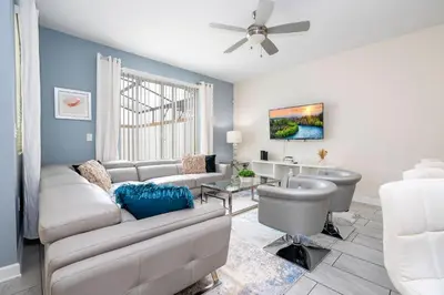 a living room with a couch and a table at Gorgeous 4 BR with pool and lake view in Kissimmee