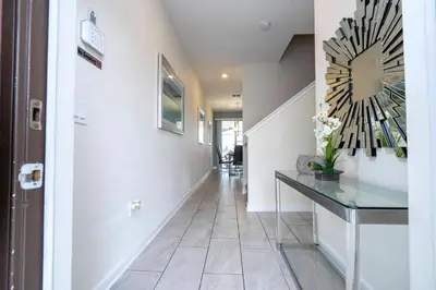 a hallway with a large clock on the wall at Gorgeous 4 BR with pool and lake view in Kissimmee