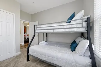 a bedroom with two bunk beds in a room at Windsor Palms Home - Pool, Theatre &Near Disney in Kissimmee
