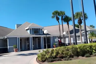 a house with palm trees in front of it at Whimsical Condo 1.5M from Disney in Orlando