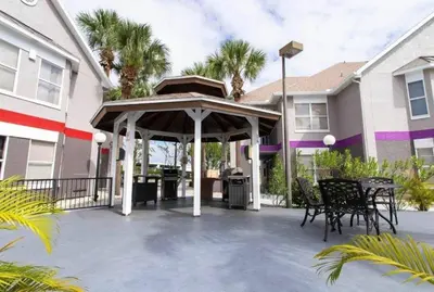 a patio with a gazebo in front of a house at Whimsical Condo 1.5M from Disney in Orlando