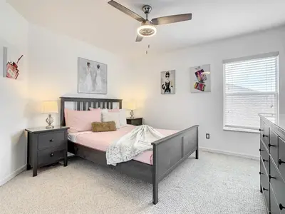a bedroom with a bed and a ceiling fan at 7BR Villa in Emerald Island w/ Resort Perks in Kissimmee