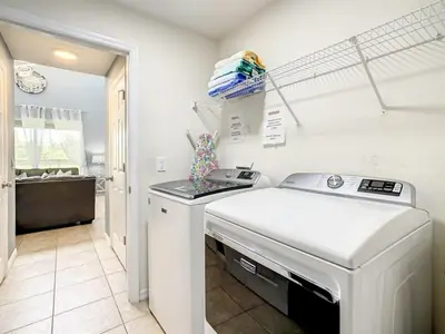 a kitchen with a washer and dryer in a room at 7BR Villa in Emerald Island w/ Resort Perks in Kissimmee