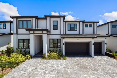 a large white house with a garage at Luxurious 15BR Villa with Lake View & Game/Theater in Orlando