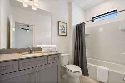 a bathroom with a sink and a toilet and a tub at Luxurious 15BR Villa with Lake View & Game/Theater in Orlando