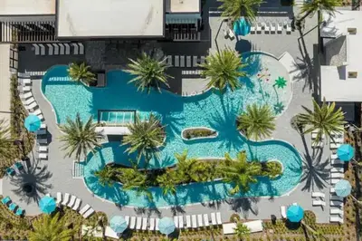 an overhead view of a swimming pool with palm trees at Luxurious 15BR Villa with Lake View & Game/Theater in Orlando