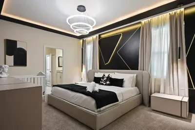 a bedroom with a bed with a black and gold wall at Epic Family Getaway: Themed Villa Near Disney ! in Kissimmee