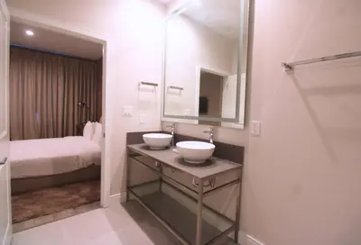 a bathroom with a sink and a mirror and a bed at NEW Luxury Oasis at Magic Village in Kissimmee