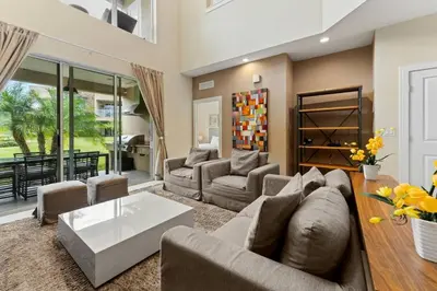 a living room with a couch and a table at Casa 4Q c/ Varandas c/ Churrasqueira – Perto Disn in Orlando