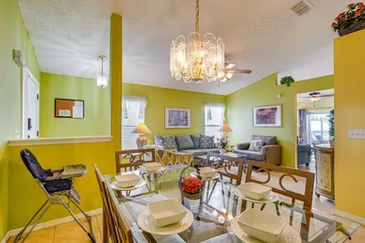 a living room with a dining table and chairs at 9 Mi to Walt Disney World Family Home with Pool! in Orlando
