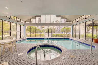 a large swimming pool with a table and chairs at Cozy Lakeview Getaway Near Universal Studios 2602 in Orlando