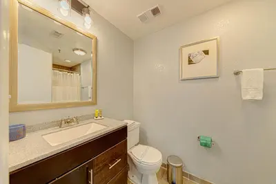 a bathroom with a sink and a toilet and a mirror at Cozy Lakeview Getaway Near Universal Studios 2602 in Orlando