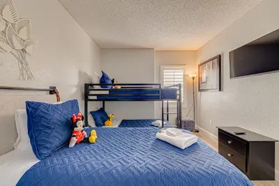 a bedroom with a bed with two stuffed animals on it at Cozy Lakeview Getaway Near Universal Studios 2602 in Orlando