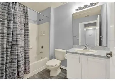 a bathroom with a toilet and a sink and a shower at 3157 YL - Encantada Serenity Retreat Elegant Villa Close to Disney in Kissimmee