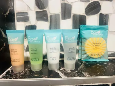 a group of four bottles of sunscreen on a shelf at The Secret Garden Games Getaway in Orlando