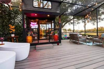 a house with a deck with a play room at FunTropicalTinyGemUCF in Orlando