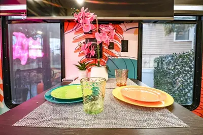 a table with two plates and a glass on it at FunTropicalTinyGemUCF in Orlando