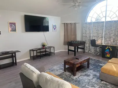 a living room with a couch and a table at 3-BR Condo near Disney & Universal in Kissimmee