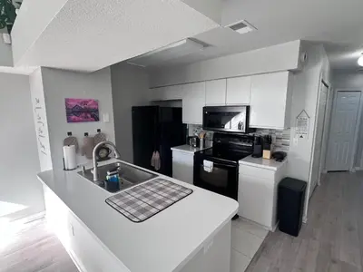 a kitchen with a sink and a counter top at 3-BR Condo near Disney & Universal in Kissimmee