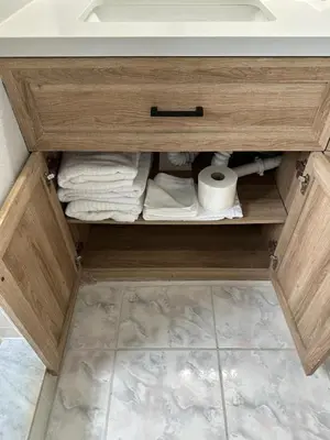 a cabinet with towels and a sink in a bathroom at 3-BR Condo near Disney & Universal in Kissimmee