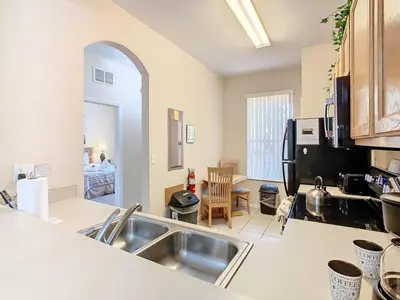 a kitchen with a sink and a counter top at Family Getaway: 4BR Townhome by Old Town in Orlando