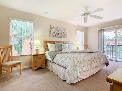 a bedroom with a bed and a ceiling fan at Family Getaway: 4BR Townhome by Old Town in Orlando