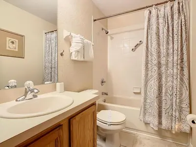 a bathroom with a sink and a toilet and a tub at Family Getaway: 4BR Townhome by Old Town in Orlando