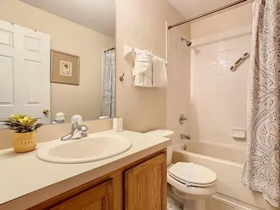 a bathroom with a sink and a toilet and a tub at Family Getaway: 4BR Townhome by Old Town in Orlando