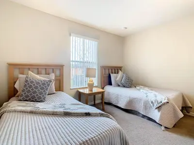a bedroom with two beds and a window at Family Getaway: 4BR Townhome by Old Town in Orlando