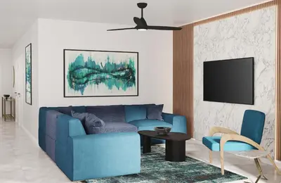 a living room with a blue couch and a tv at Villatel Orlando Resort, Apartments by Marriott Bonvoy in Orlando