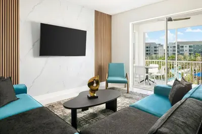 a living room with a couch and a tv at Villatel Orlando Resort, Apartments by Marriott Bonvoy in Orlando