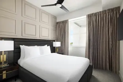 a bedroom with a large white bed and a window at Villatel Orlando Resort, Apartments by Marriott Bonvoy in Orlando