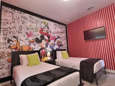 a room with two beds and a wall with a mural at 5BR c/Piscina Privada | Luxo em Storey Lake in Kissimmee