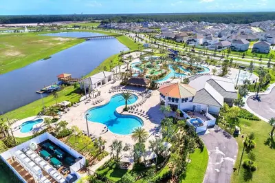 an aerial view of a resort with a pool at 5BR c/Piscina Privada | Luxo em Storey Lake in Kissimmee
