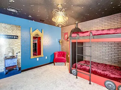 a bedroom with a bunk bed and a red chair at Magical Mansion - 15 Min to Disney - Storey Lake in Kissimmee