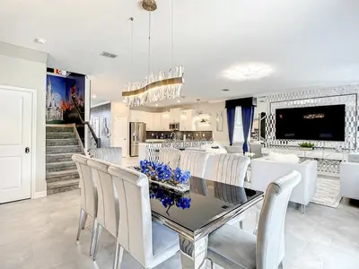 a kitchen and dining room with a table and chairs at Magical Mansion - 15 Min to Disney - Storey Lake in Kissimmee