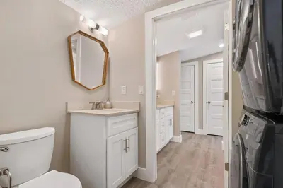 a bathroom with a toilet and a sink and a mirror at Great Outdoor Area in Orlando