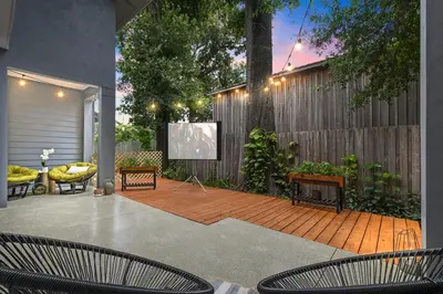 a patio with chairs and a screen on a fence at Great Outdoor Area in Orlando