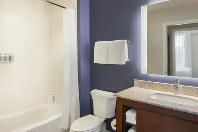 a bathroom with a white toilet and a sink at Residence Inn by Marriott Orlando Downtown in Orlando