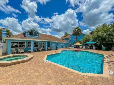 a swimming pool in front of a house at Apartamento 3 Quartos a Minutos da Disney in Kissimmee