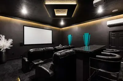 a movie room with leather chairs and a blank screen at The Nicklaus View Haven-TB007 in Orlando