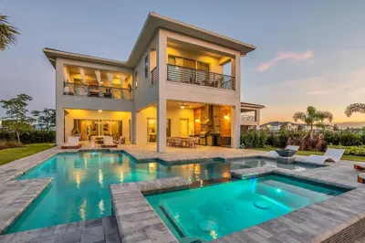 a home with a swimming pool and a house at The Luxurious Bear's Den Estate-TB009 in Orlando