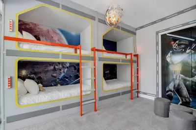 two bunk beds in a room with a mural at The Luxurious Bear's Den Estate-TB009 in Orlando