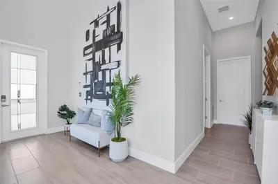 a living room with a couch and a plant at The Luxurious Bear's Den Estate-TB009 in Orlando