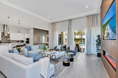 a living room with white furniture and a kitchen at The Luxurious Bear's Den Estate-TB009 in Orlando