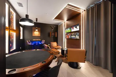 a living room with a table and chairs and a room with a tv at 2858 Storey Lake brand new 19guests pool game room in Kissimmee